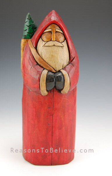 a wooden santa clause with a tree on his head and hat, sitting in a red log