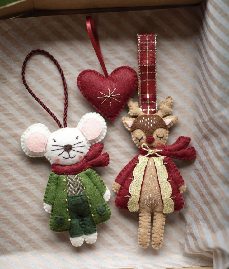 two ornaments in the shape of mice and a mouse