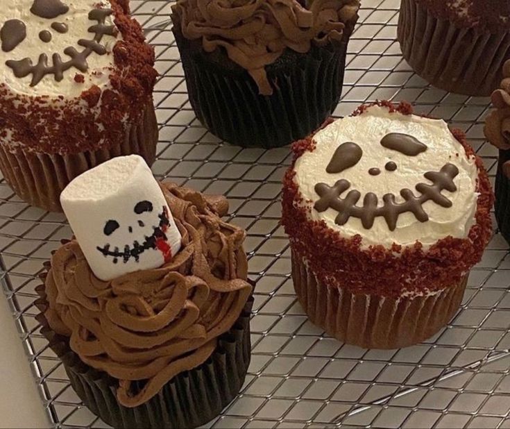 cupcakes decorated with frosting and spooky decorations