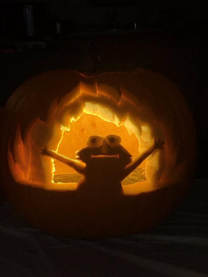 a close up of a pumpkin with a face carved into it