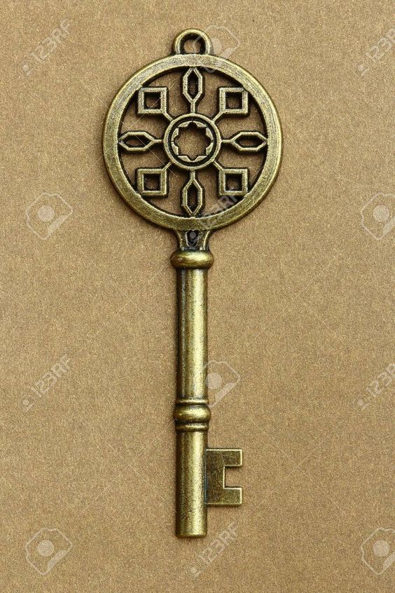 an antique key on a brown background with room for text stock photo, picture and royalty