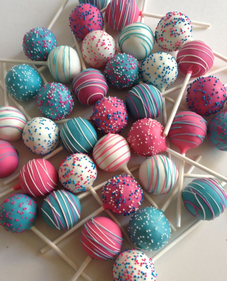 cake pops with sprinkles are arranged on a stick