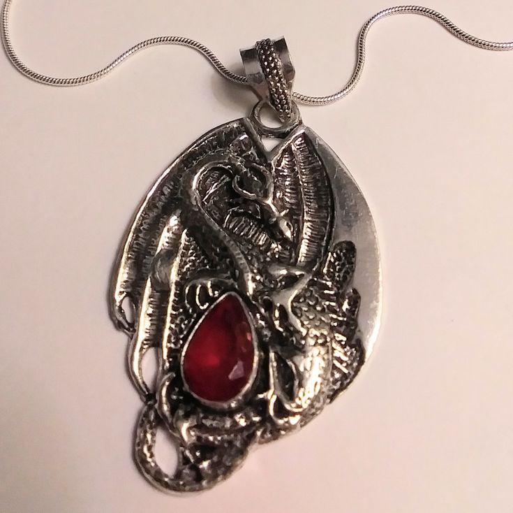 Stunning 925 Sterling Silver Garnet Dragon Necklace. 925 Sterling Silver. 20 Inches N Chain Length. 3 Inches N Pendant Length. 3 Carats Of Garnet Stones. This Will Be A Nice Addition To Your Jewelry Collection. Garnet Acts As A 'Luck-Ener' - It Makes You Lucky For Love, Success And Even Financial Gain By Keeping You Balanced, Confident And Protected 100% Authentic Stones, 925 Sterling Silver. This Will Be A Nice Addition To Your Jewelry Collection. Thanks For Dropping In An Checking My Closet Ou Silver Dragon Jewelry, Valyrian Necklace, Silver Ruby Jewelry For Gift, Red Engraved Round Necklaces, Red Teardrop Sterling Silver Jewelry, Red Engraved Round Necklace, Nickel-free Red Sterling Silver Jewelry, Red Nickel-free Sterling Silver Jewelry, Red Gemstone Sterling Silver Necklace