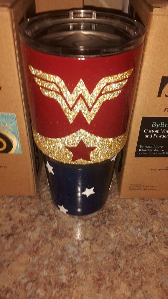 the wonder woman coffee cup is next to its box