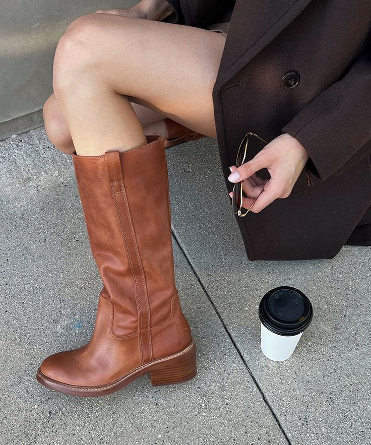 This season, we're drawing inspo from our favorite vintage booties—and adding a few twists of our own. ILLORA pairs a tall shaft with a chunky, sculptural stacked heel—and the effect is total perfection. We'll be wearing these scene-stealing boots well into next season. Leather Upper Rubber Outsole Recycled Textile Lining Water-based Leather Alternative Sock 13.8" Shaft Height 12.2" Leg Circumference 1.9" Heel Height Imported 70s Boots Outfit, Boot Outfit Women, Tall Brown Boots Outfit, Mid Calf Boots Outfit, Frye Boots Outfit, Women Brown Boots, 70s Boots, Campus Boots, Autumn Boots