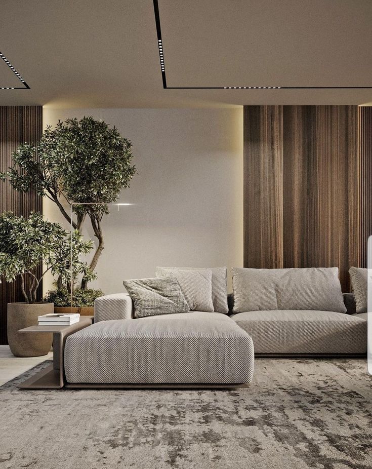 a living room filled with furniture and a tree in the corner on the wall behind it