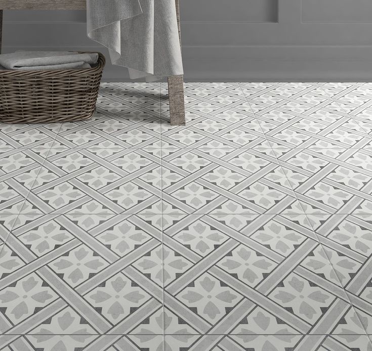 a bathroom with grey and white tiles on the floor