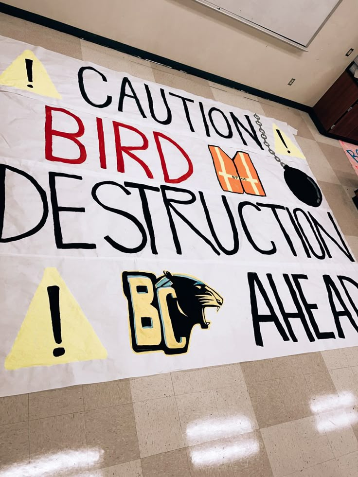 a sign that says caution bird destruction is posted on the floor in an office building