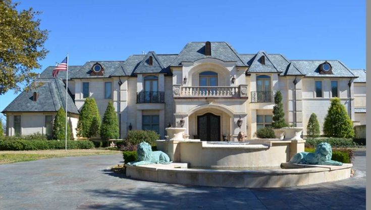 a large house with statues in front of it