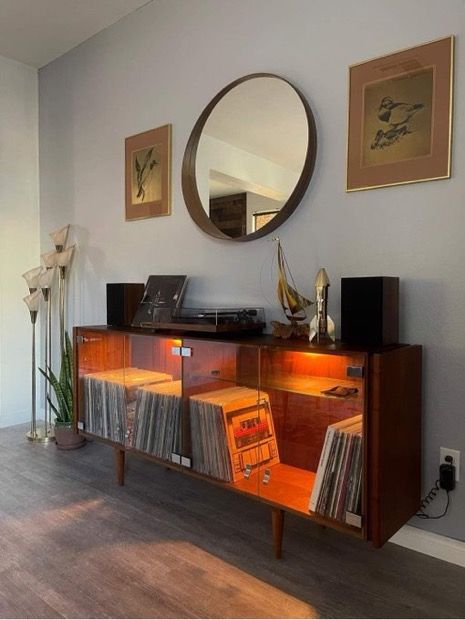 a record player is sitting on top of an entertainment center in the corner of a room