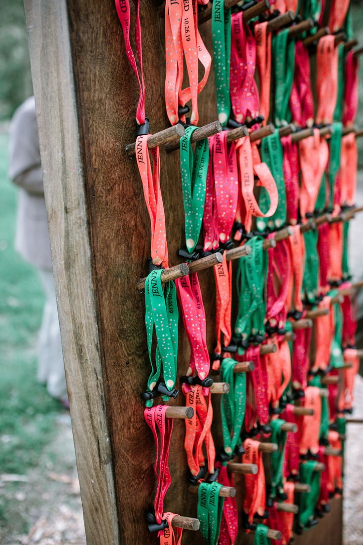 colorful ribbons are hanging on the side of a wooden structure