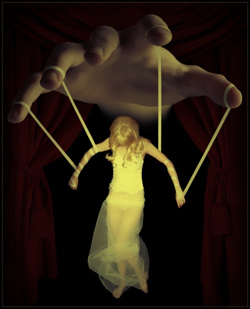 a woman is suspended in the air with strings attached to her body and hands behind her