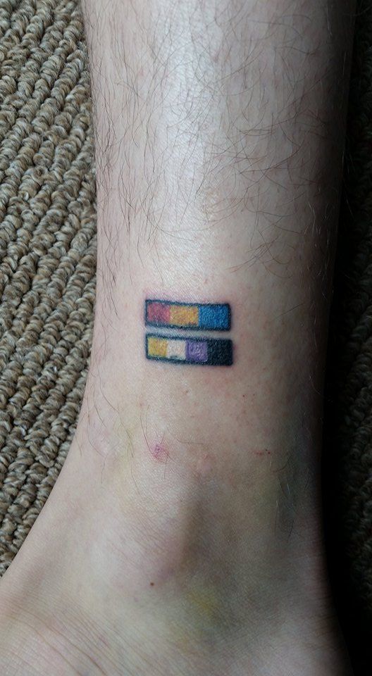 a person with a small tattoo on their foot that has two strips of colored ink