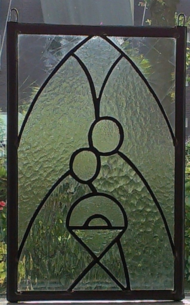 a stained glass window with an image of a person holding a baby in it's arms