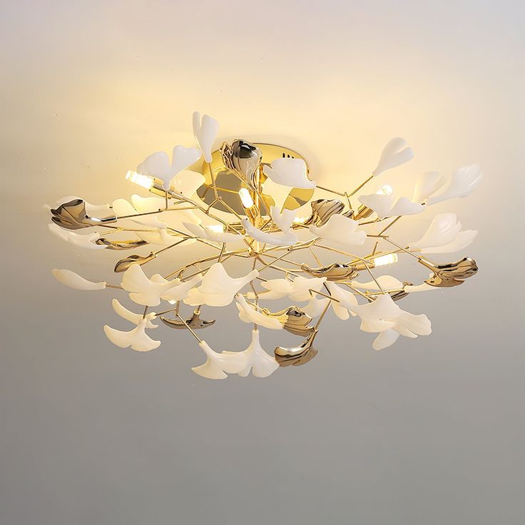 a chandelier with white flowers hanging from the ceiling