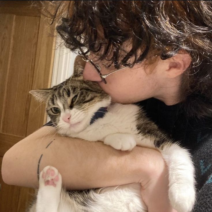 a woman holding a cat in her arms