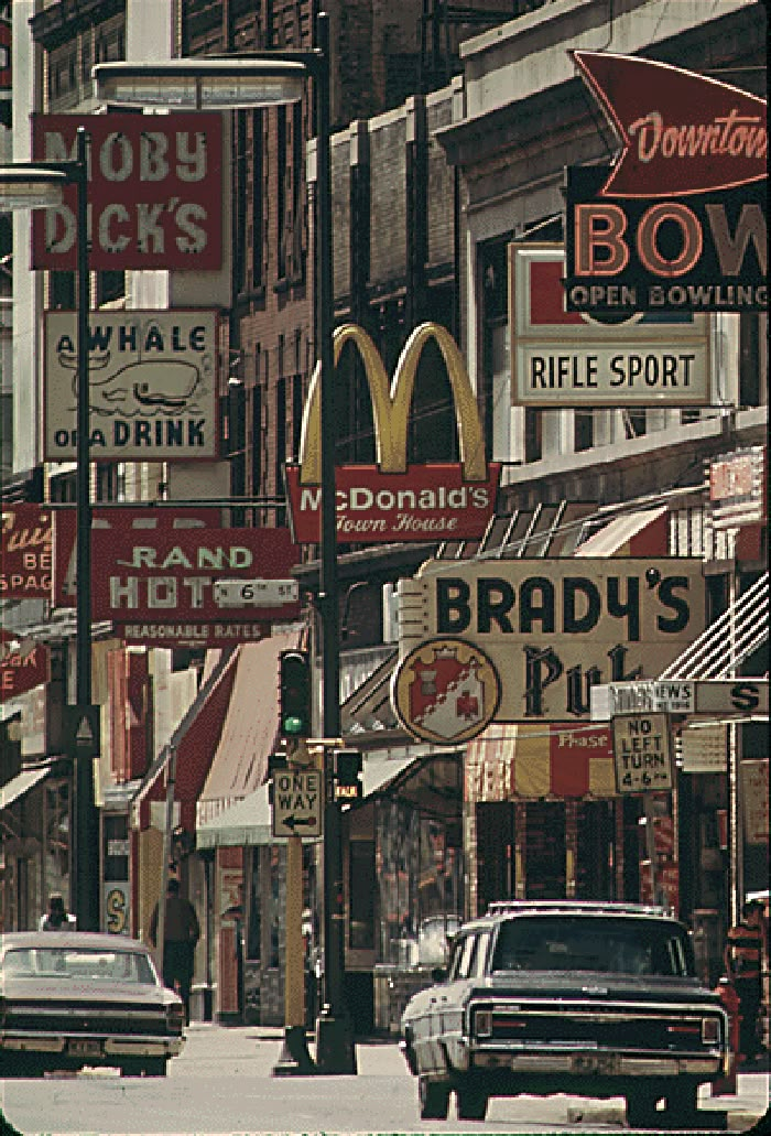 many signs on the side of buildings and cars