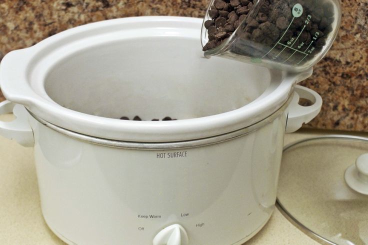 a white crock pot filled with food on top of a counter