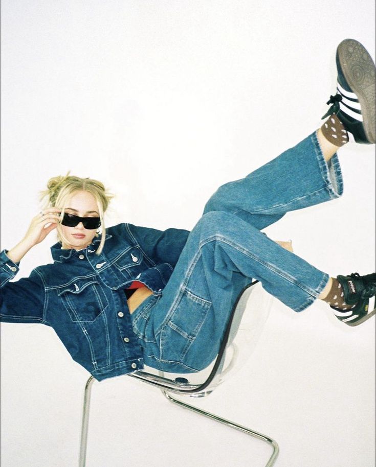 a woman sitting in a chair with her legs crossed and feet up on the ground