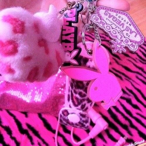 a hello kitty keychain is shown on a zebra print tablecloth with pink and white accessories