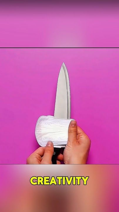 a person holding a knife with the words creativity on it in front of a purple background