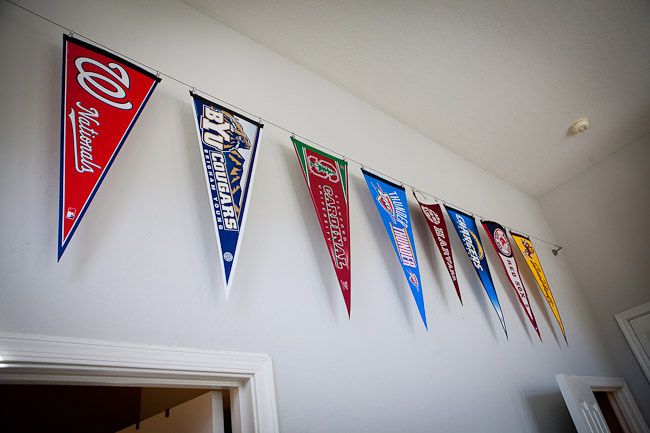 several baseball pennants hanging on the wall