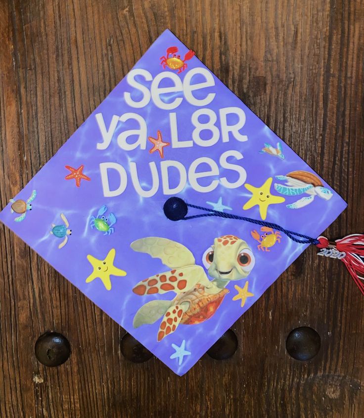 a purple graduation cap that says see ya lar dudes on it with an image of a sea turtle