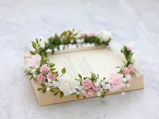 a flower crown on top of an old book