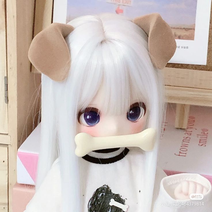 a doll with long white hair has a bone in her mouth