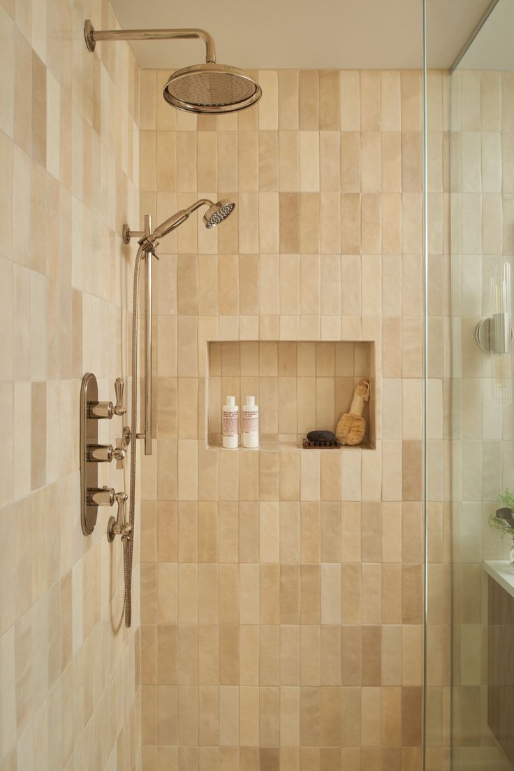 a bathroom with a walk in shower next to a sink