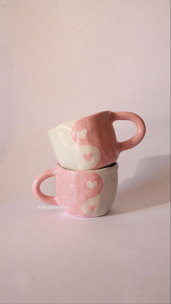 two pink and white cups with hearts on them