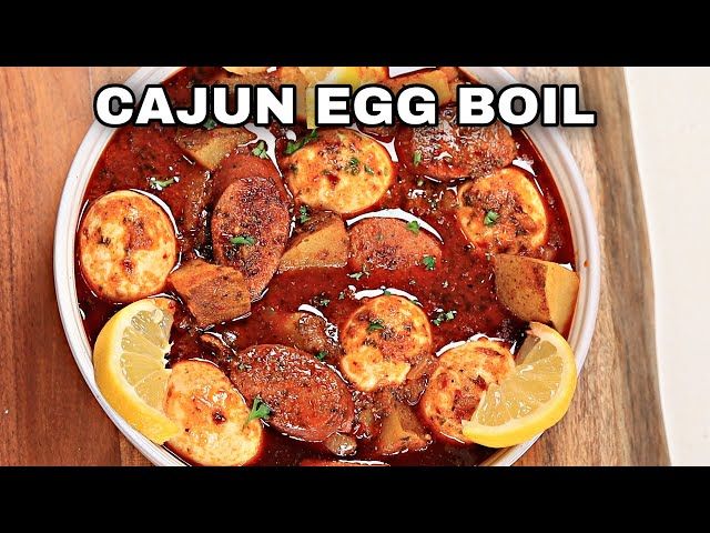 a bowl filled with food on top of a wooden table and the words cajun egg boil above it