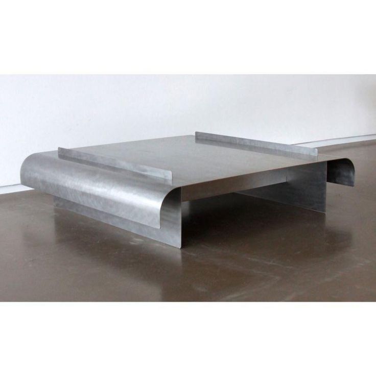 a metal table sitting on top of a hard wood floor