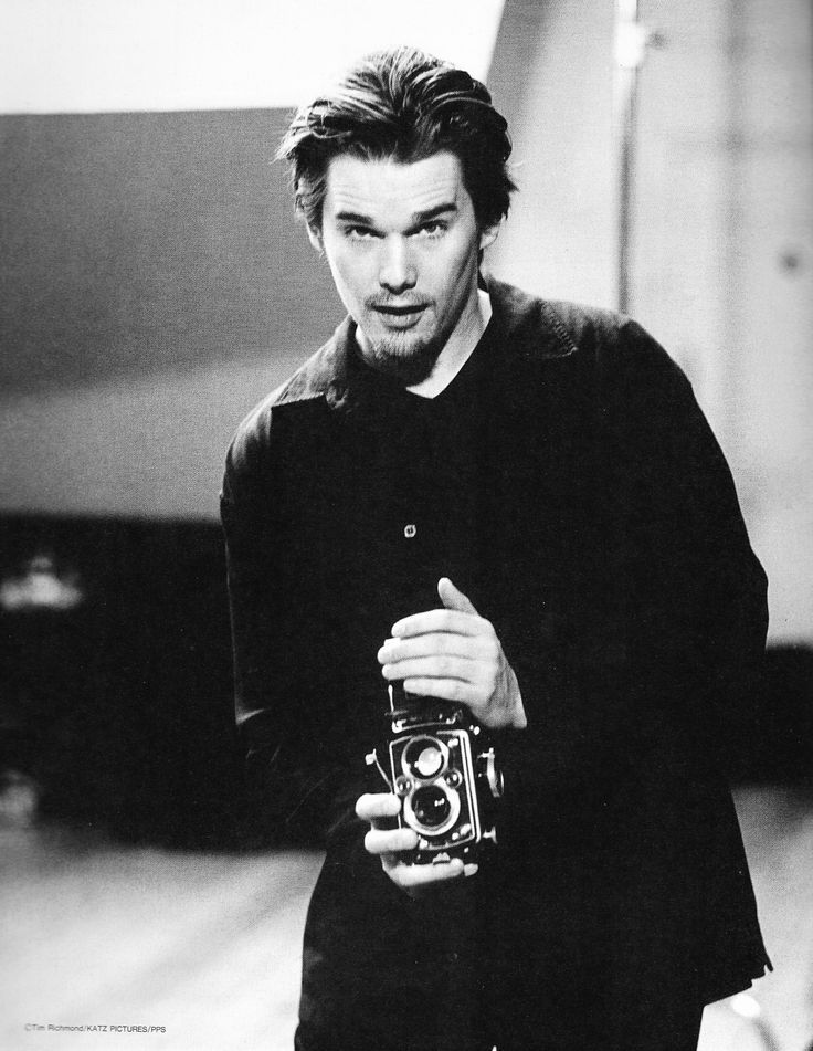 black and white photograph of a man holding a camera