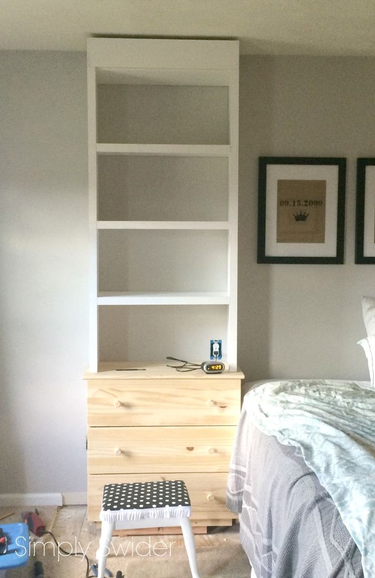 a bedroom with a bed, dresser and pictures on the wall