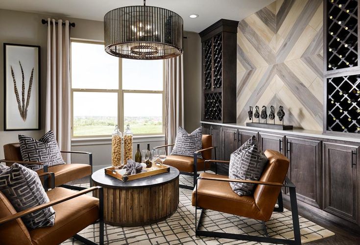 a living room filled with lots of furniture and a chandelier hanging from the ceiling