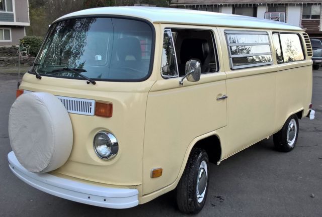 an old yellow van parked in a parking lot