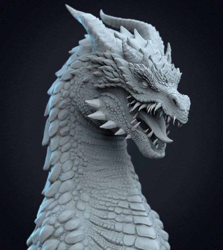 a close up of a dragon statue on a black background with the head turned to look like it has sharp teeth