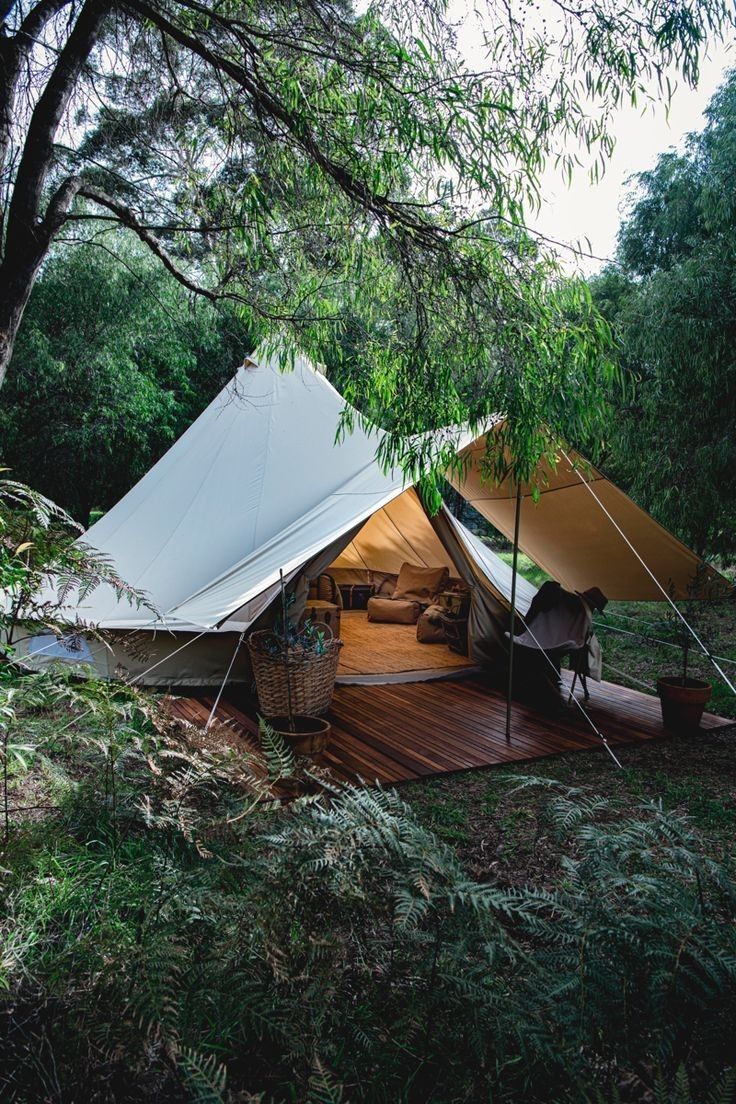 a tent is set up in the woods