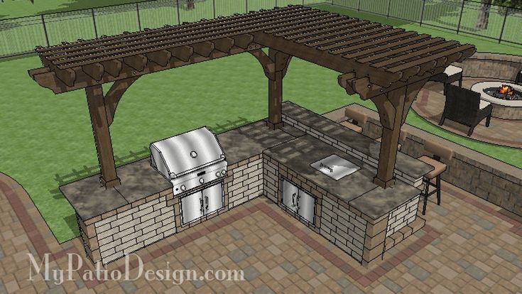 an outdoor kitchen with grill and seating area