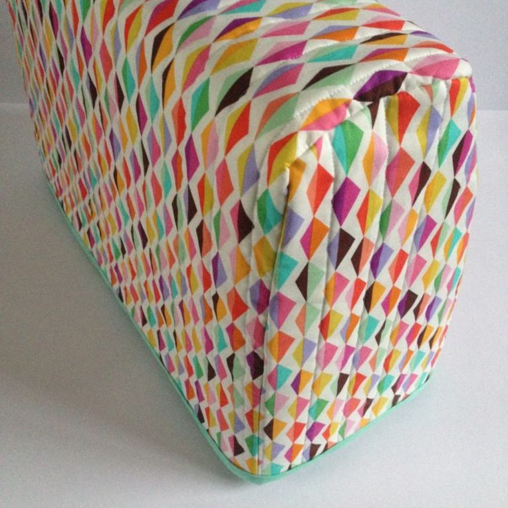 a multicolored bag sitting on top of a white table