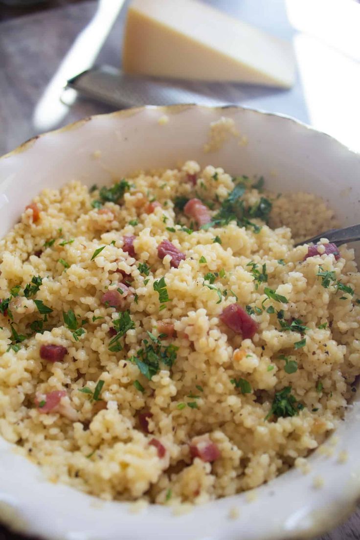 a white bowl filled with food on top of a table