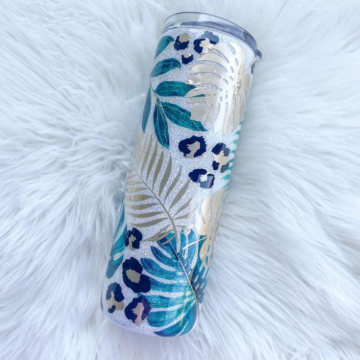 a blue and gold floral print tumbler cup on a white furnishing area