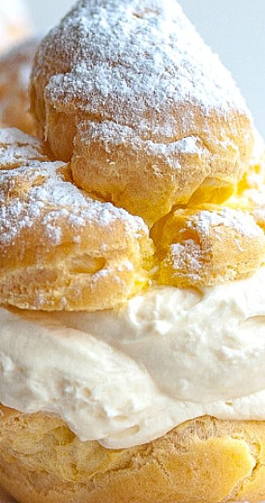 three donuts stacked on top of each other with icing and powdered sugar