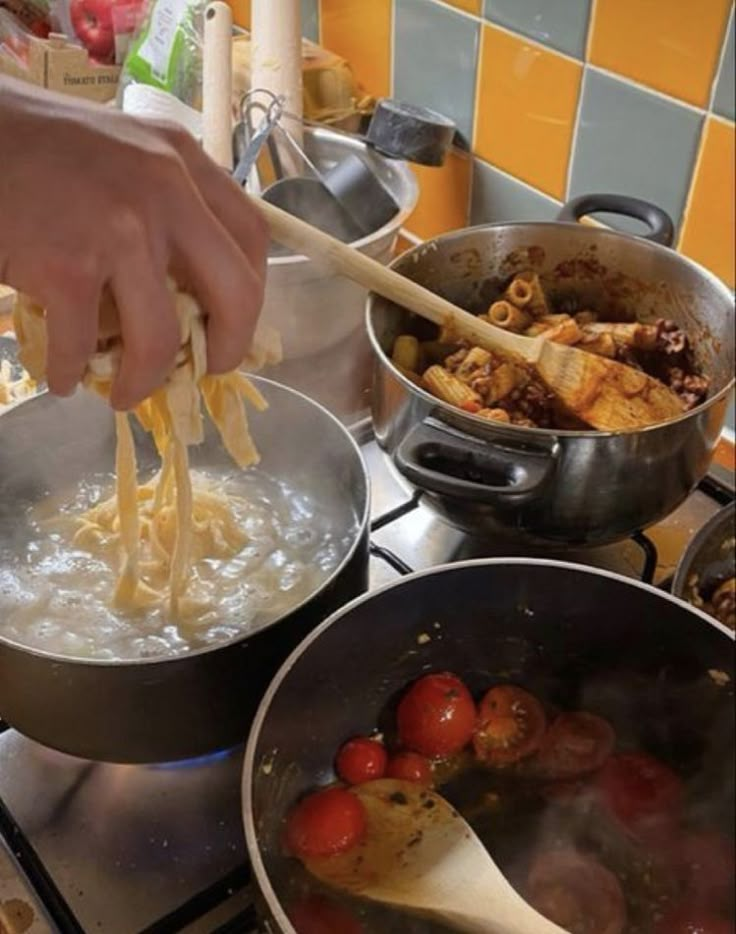 a person is stirring food in a pot on the stove