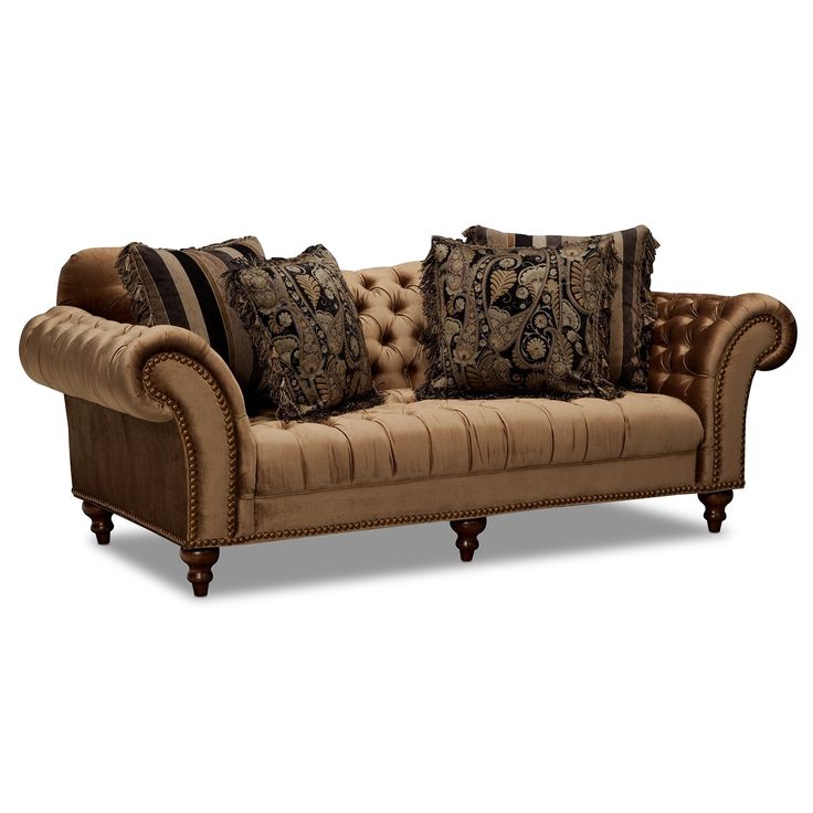 a brown couch with pillows on top of it