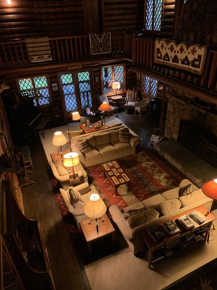 a living room filled with lots of furniture next to a fire place in a building