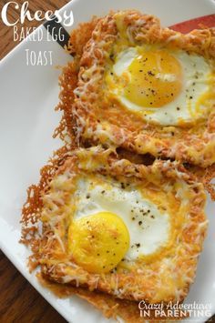 two pieces of hash browns with an egg in the middle on a white square plate