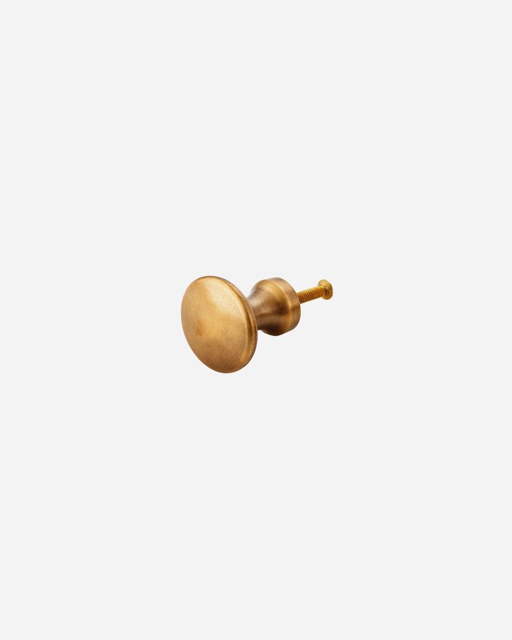 a gold door knob on a white background