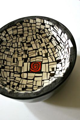 a black and white bowl sitting on top of a table